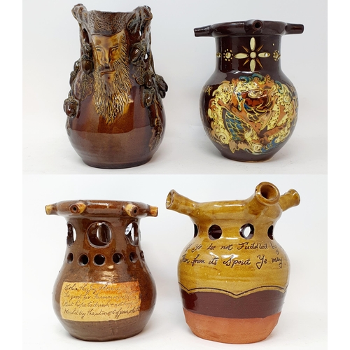 570 - A Brannam Pottery puzzle jug, 8 cm high, and three other puzzle jugs (4)