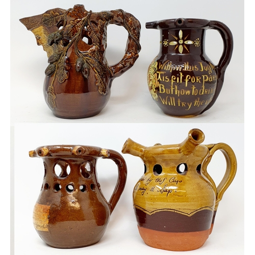 570 - A Brannam Pottery puzzle jug, 8 cm high, and three other puzzle jugs (4)