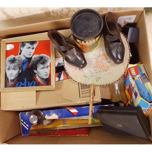 714 - A 1980s Rubix cube, boxed, a pair of child's leather shoes, and assorted other items (box)