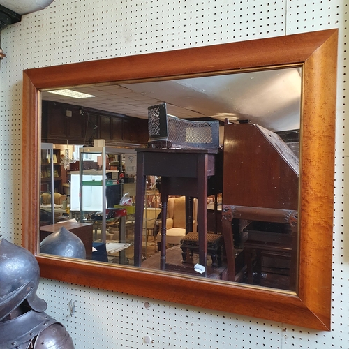 942 - *** Regretfully Withdrawn*** A wall mirror, in a birdseye maple frame, 75 x 106cm