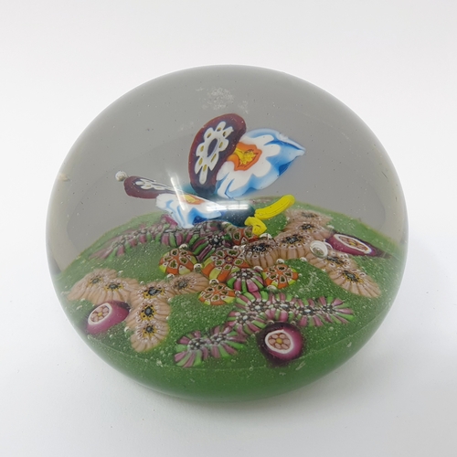 667 - A millefiori paperweight, decorated butterfly, 10 cm diameter