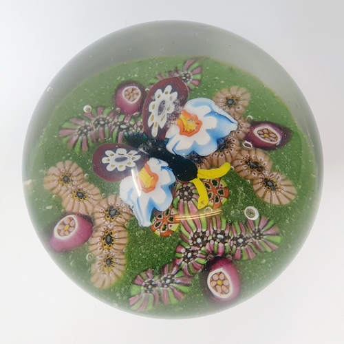 667 - A millefiori paperweight, decorated butterfly, 10 cm diameter