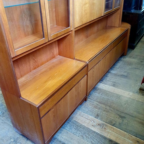 1064 - A large teak display cabinet by William Lawrence in sections