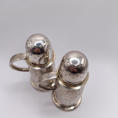 98 - A pair of modernist chased silver pepperettes, of good gauge and slender baluster form, London 2002,... 