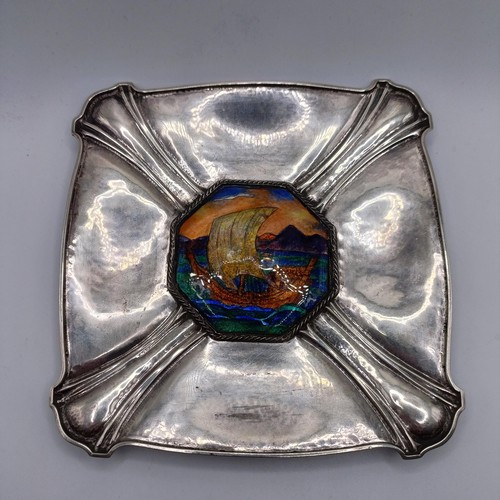 83 - A silver dish, of shaped rectangular form, the centre applied an octagonal plaque, decorated a ship,... 