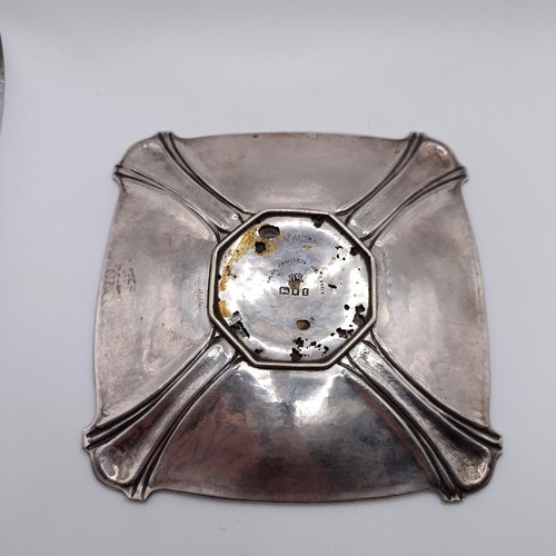 83 - A silver dish, of shaped rectangular form, the centre applied an octagonal plaque, decorated a ship,... 