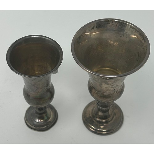 50 - A silver coloured metal kiddish cup, 10 cm high, and another (2)