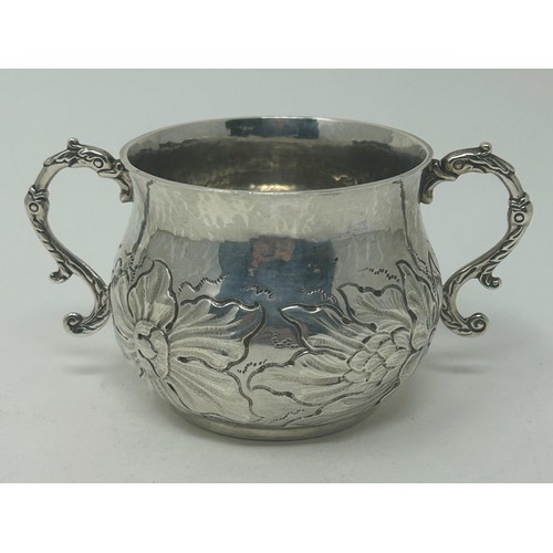 31 - A Charles II style silver porringer, embossed flowers and foliage, London 1913, 6.2 ozt, 7 cm high