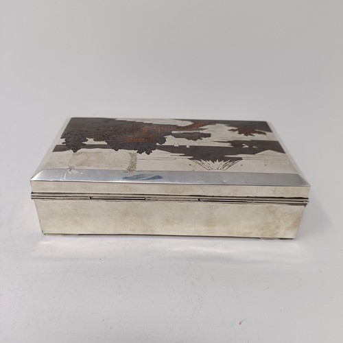 81 - A Japanese silver table cigarette box, decorated a snowcapped mountain, 15.5 cm wide