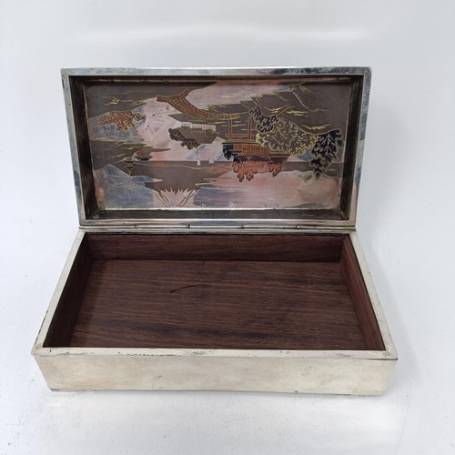 81 - A Japanese silver table cigarette box, decorated a snowcapped mountain, 15.5 cm wide