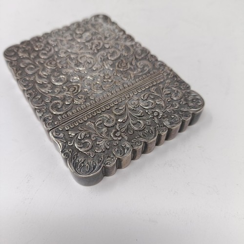 119 - An Indian silver coloured metal visiting card case, initialled, decorated scrolling foliage, 9.5 cm