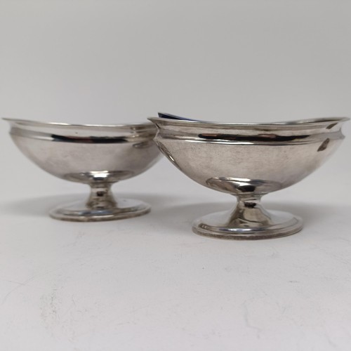 95 - A pair of Chinese silver coloured metal oval pedestal salts, of European influence, with blue glass ... 