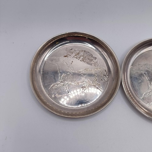 43 - A pair of Continental silver coloured metal dishes, engraved horses, the underside inscribed and dat... 