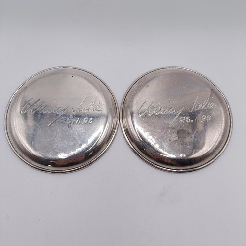 43 - A pair of Continental silver coloured metal dishes, engraved horses, the underside inscribed and dat... 