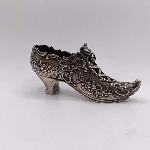 199 - A novelty silver shoe, with embossed decoration, import marks, 12 cm