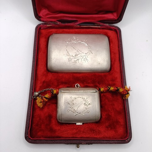 136 - A Continental silver coloured metal cigarette case, and a matching snuff box, named, in a fitted cas... 