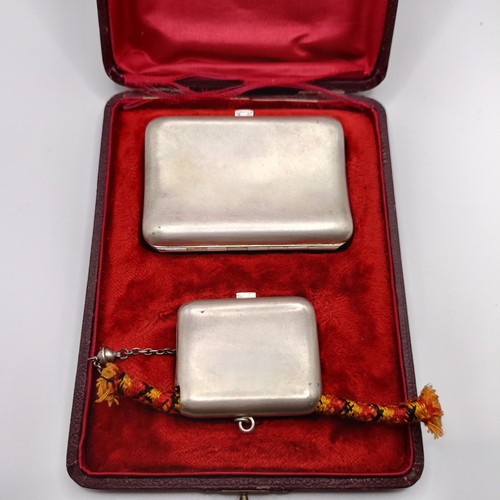 136 - A Continental silver coloured metal cigarette case, and a matching snuff box, named, in a fitted cas... 