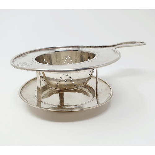 25 - A Chinese silver coloured metal tea strainer, on a stand, initialled, Wingon