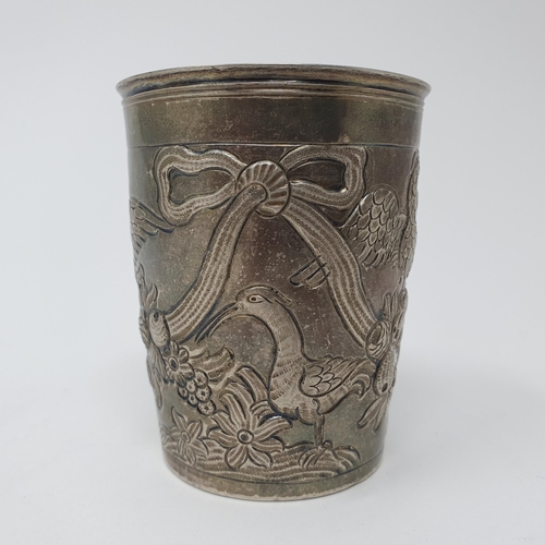 100 - A French silver beaker, embossed birds, ribbons and foliage, 8 cm high