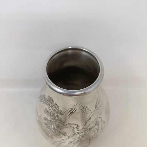 40 - A Japanese silver coloured metal vase, of baluster form, decorated a mountain scene, signed, 17.5 cm... 