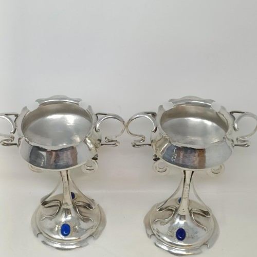 5 - A pair of Art Nouveau silver pedestal cups, applied blue cabochon stones, Mappin & Webb, Sheffield 1... 