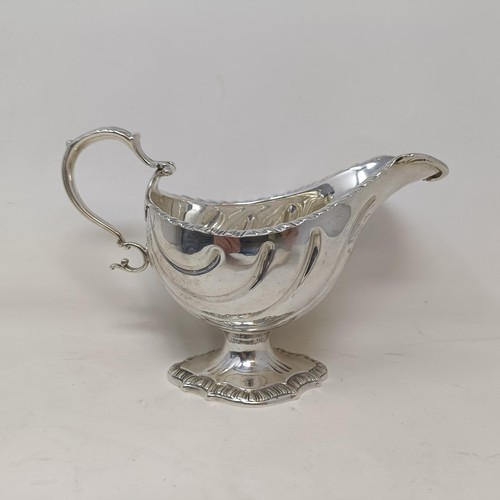 28 - A George III silver sauce boat, engraved an armorial, probably London 1766, 9 ozt, 12 cm high