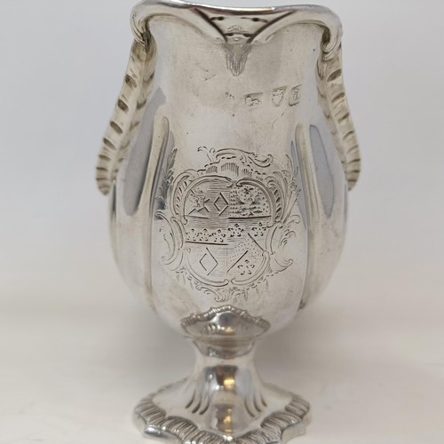 28 - A George III silver sauce boat, engraved an armorial, probably London 1766, 9 ozt, 12 cm high