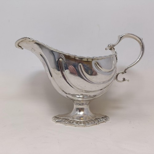 28 - A George III silver sauce boat, engraved an armorial, probably London 1766, 9 ozt, 12 cm high