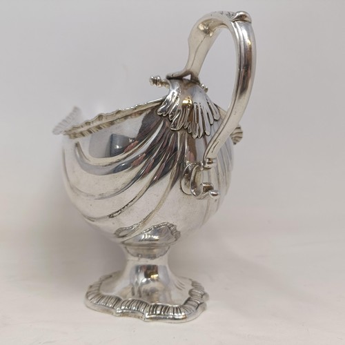 28 - A George III silver sauce boat, engraved an armorial, probably London 1766, 9 ozt, 12 cm high