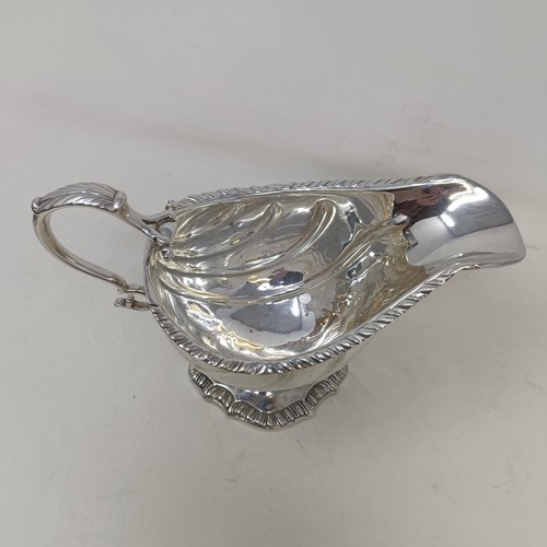 28 - A George III silver sauce boat, engraved an armorial, probably London 1766, 9 ozt, 12 cm high