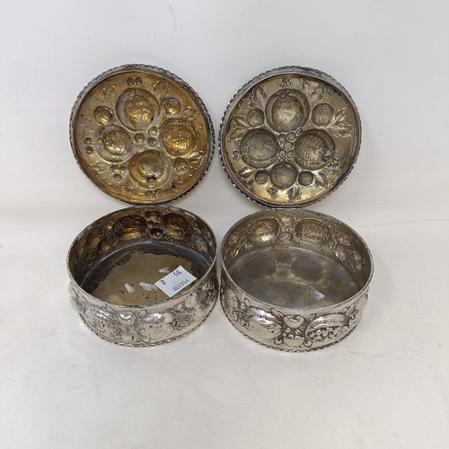 21 - A pair of Continental silver coloured metal boxes and covers, embossed fruit in high relief, 9 cm di... 