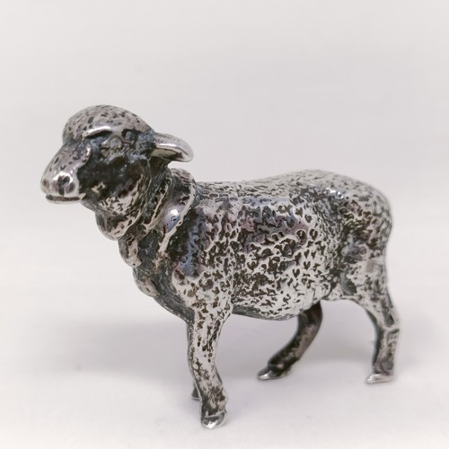 11 - A silver figure, in the form of a cherub riding a pig, some losses, and a silver coloured metal mode... 