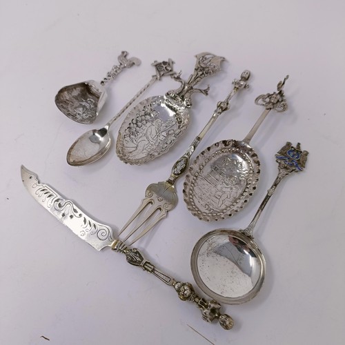 34 - A Continental silver coloured metal caddy spoon, assorted other spoons, and a knife and fork