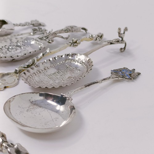 34 - A Continental silver coloured metal caddy spoon, assorted other spoons, and a knife and fork