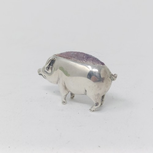 37 - A silver coloured metal pin cushion, in the form of a pig, 4 cm wide