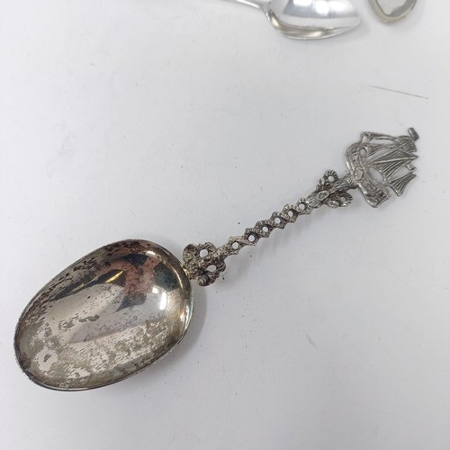 67 - A Contintenal silver coloured metal spoon, with a ship finial, a pepper pot and assorted spoons