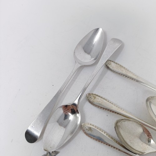 74 - A Continental silver coloured metal caddy spoon, with a goat finial, and assorted other spoons