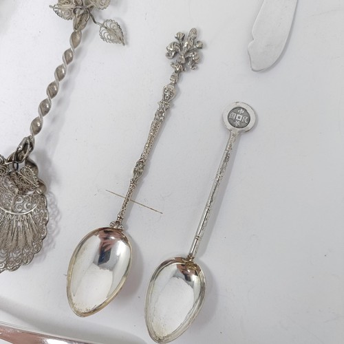 74 - A Continental silver coloured metal caddy spoon, with a goat finial, and assorted other spoons