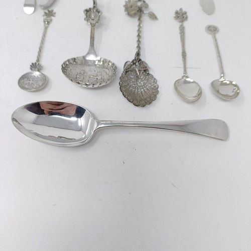 74 - A Continental silver coloured metal caddy spoon, with a goat finial, and assorted other spoons