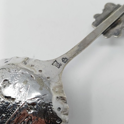 74 - A Continental silver coloured metal caddy spoon, with a goat finial, and assorted other spoons