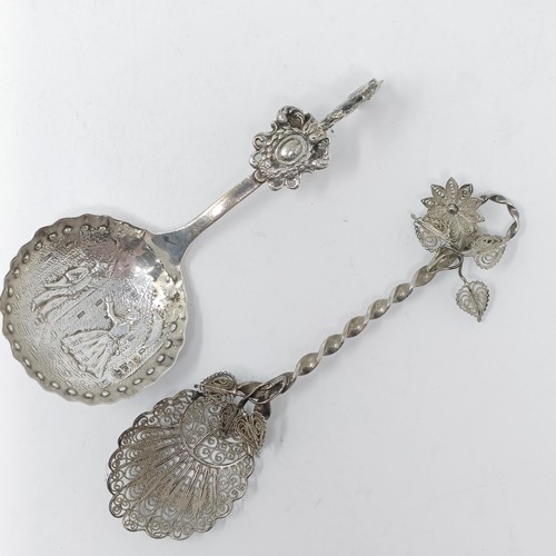 74 - A Continental silver coloured metal caddy spoon, with a goat finial, and assorted other spoons