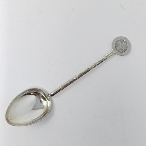 74 - A Continental silver coloured metal caddy spoon, with a goat finial, and assorted other spoons