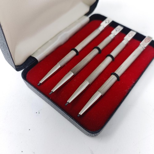 90 - A set of four sterling silver bridge pencils, cased