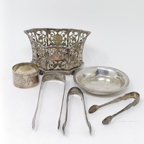 109 - A George V silver pierced bowl, a napkin ring, a  silver dish, three pairs of sugar tongs, 7.9 ozt