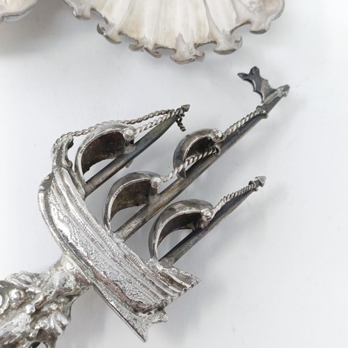 110 - A Continental silver coloured metal spoon, with a ship finial, and four other silver coloured metal ... 