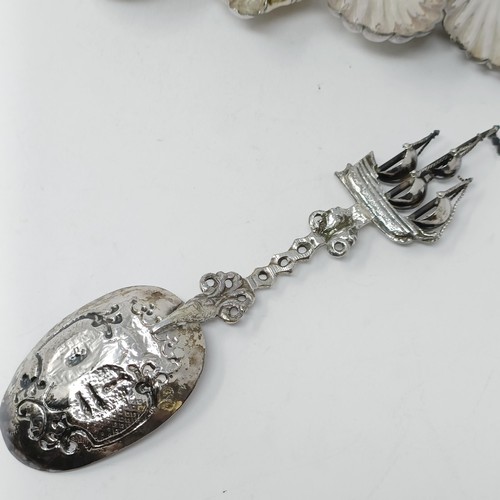 110 - A Continental silver coloured metal spoon, with a ship finial, and four other silver coloured metal ... 