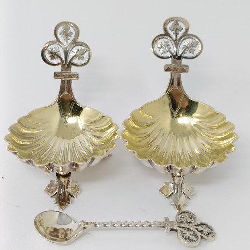 124 - A pair of Victorian silver salts, in the form of shells, Sheffield 1872, and a single salt spoon