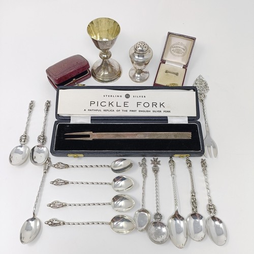 141 - A modern silver pickle fork, a silver goblet, a pepper pot, assorted silver spoons and two jewellery... 