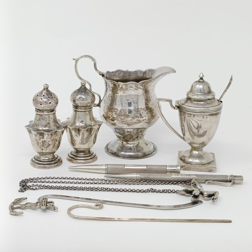 145 - A George III silver cream jug, a pair of peppers, a salt, with a blue glass liner, 4.9 ozt, two silv... 