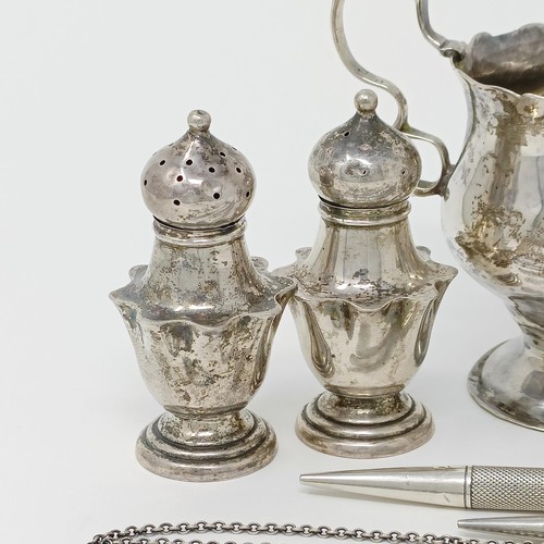 145 - A George III silver cream jug, a pair of peppers, a salt, with a blue glass liner, 4.9 ozt, two silv... 